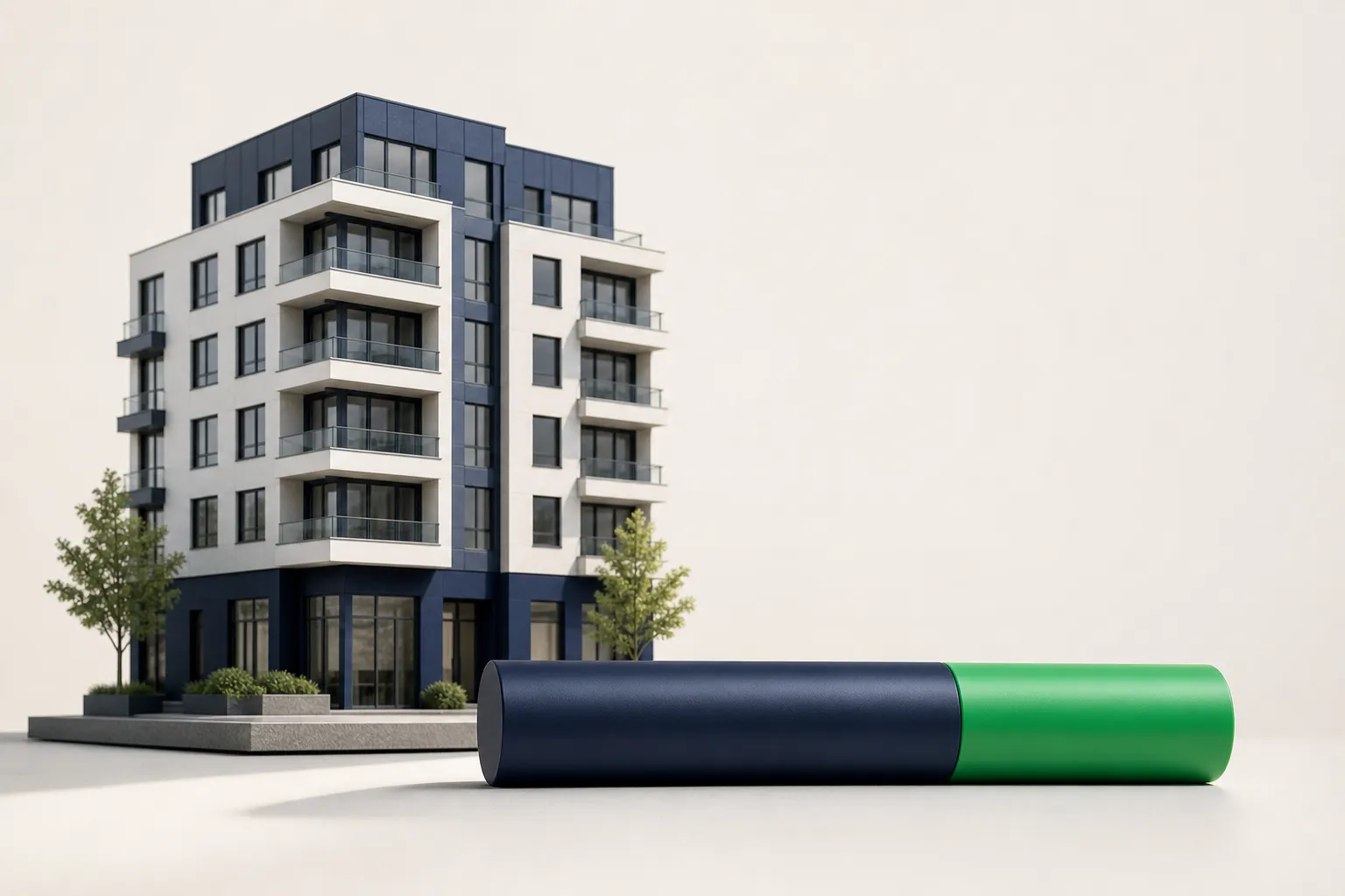 An architectural miniature apartment building beside a two-toned cylindrical bar with an emerald section illustrating a rental affordability ratio.